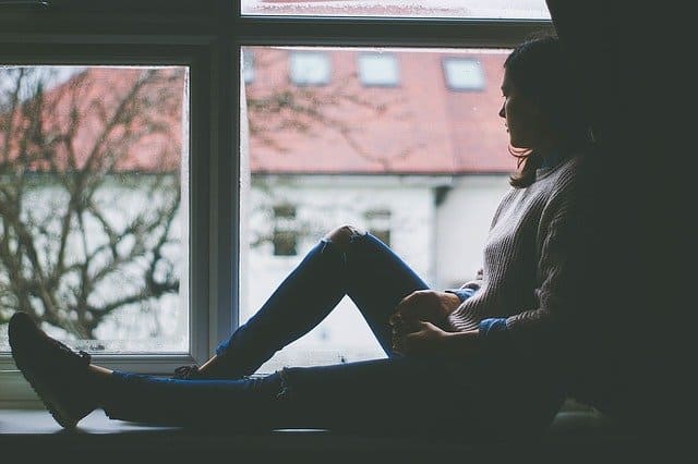 Girl sitting at window
